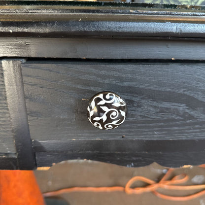 Black wooden drawer with a decorative silver handle