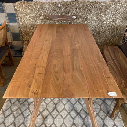 Wooden dining table with chairs in a room setting