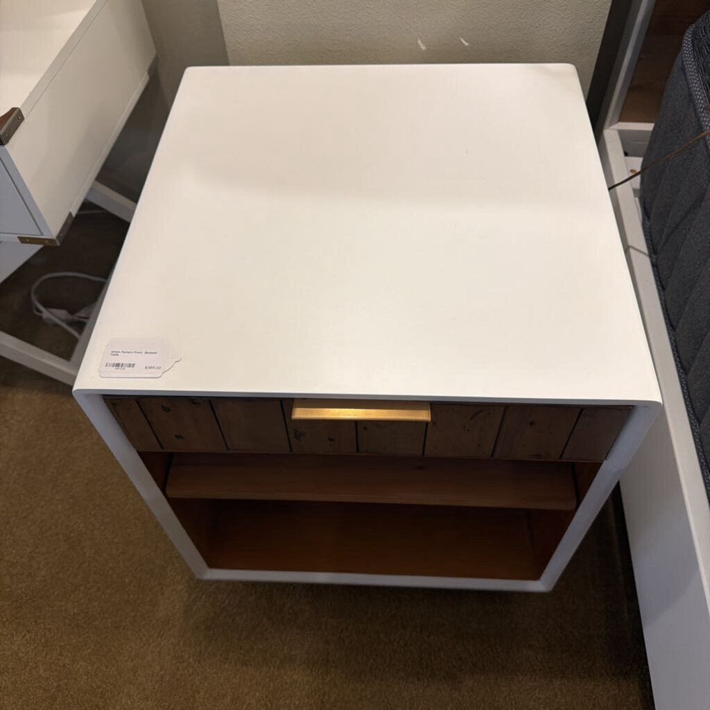 White table with wooden shelf in a room setting