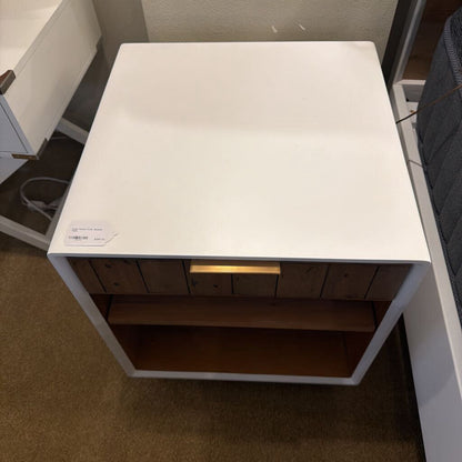 White table with wooden shelf in a room setting