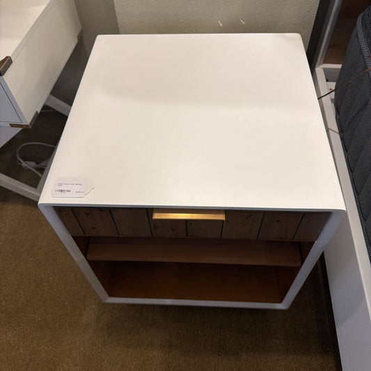 White table with wooden shelf in a room setting