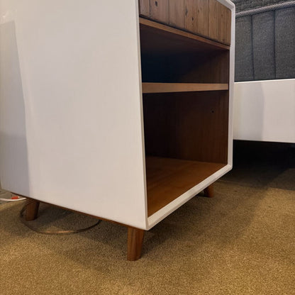 White cabinet with wooden shelves on a carpeted floor
