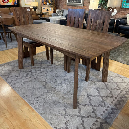Wooden dining table with chairs in a room setting