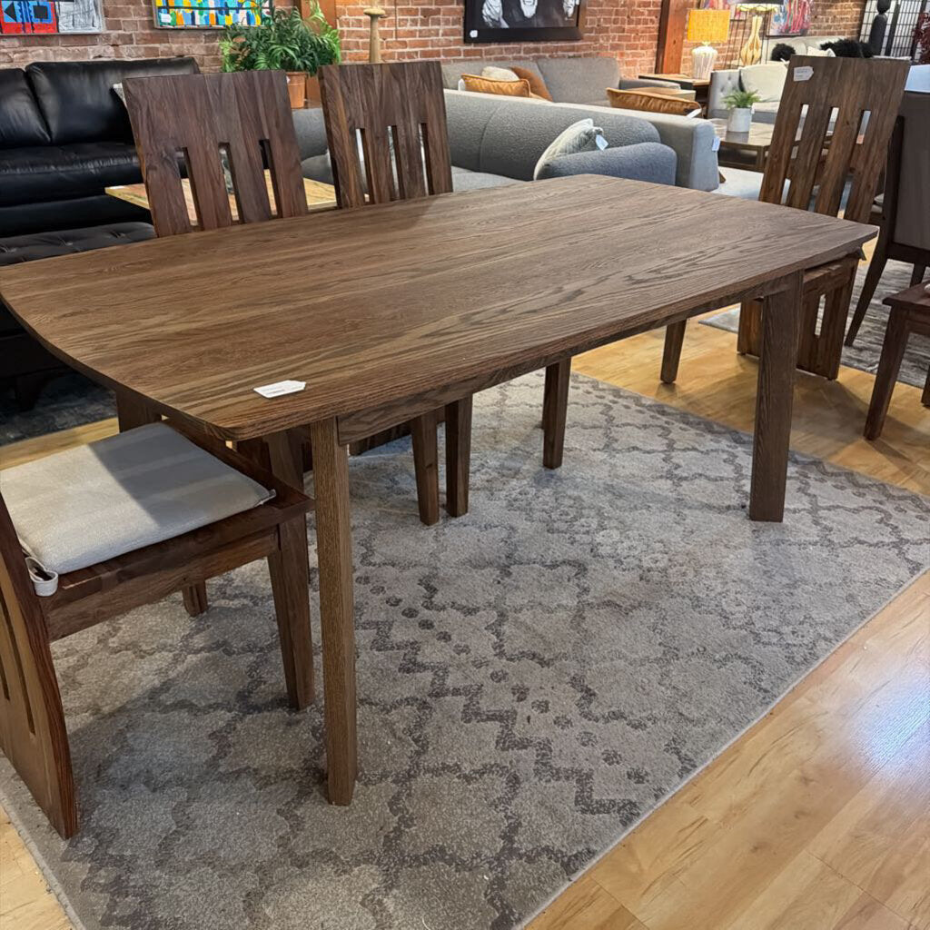 Wooden dining table with chairs in a living room setting