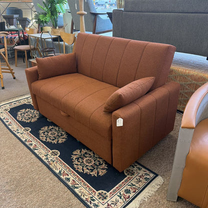 Brown sofa with a price tag in a furniture store setting