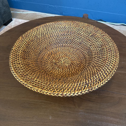 Woven basket on a wooden surface with a blue wall in the background