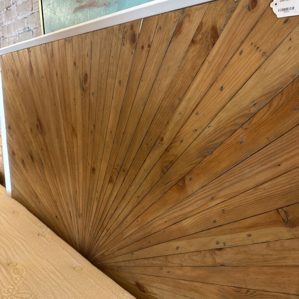 Wooden panel with a sunburst pattern on a white background