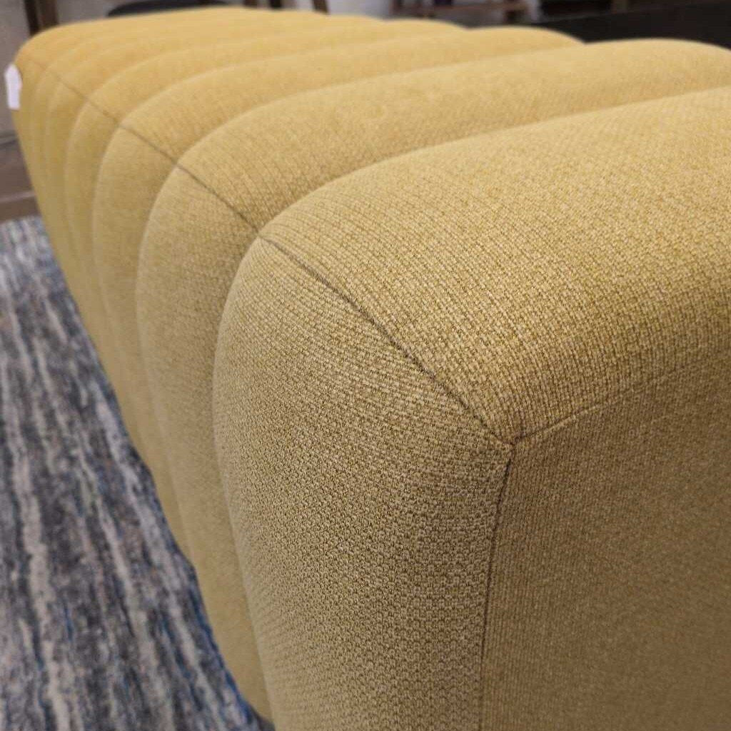 Close-up of a textured yellow cushion on a chair