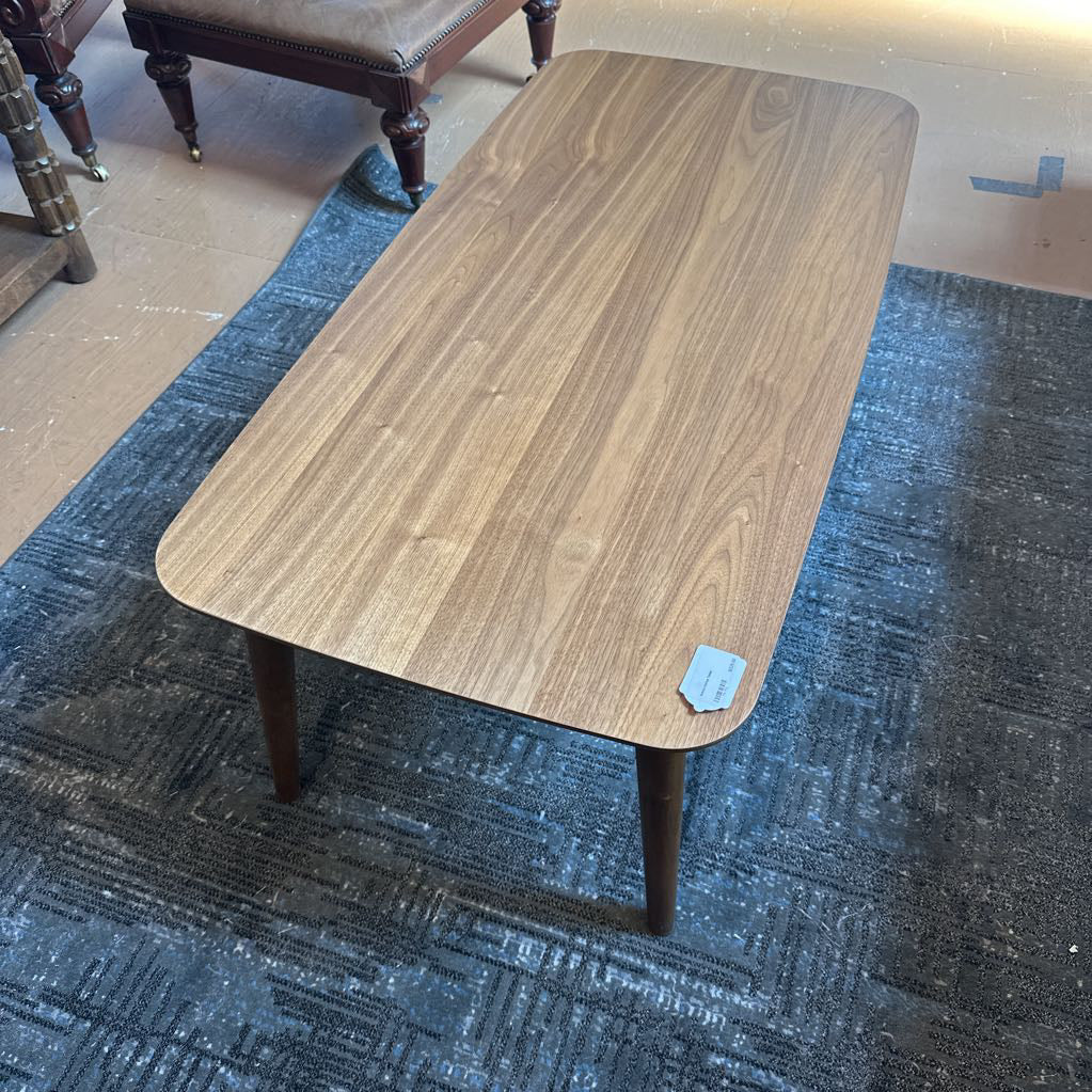 Wooden coffee table on a blue carpeted floor