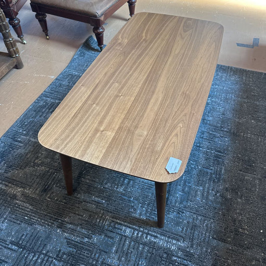 Wooden coffee table on a blue carpeted floor