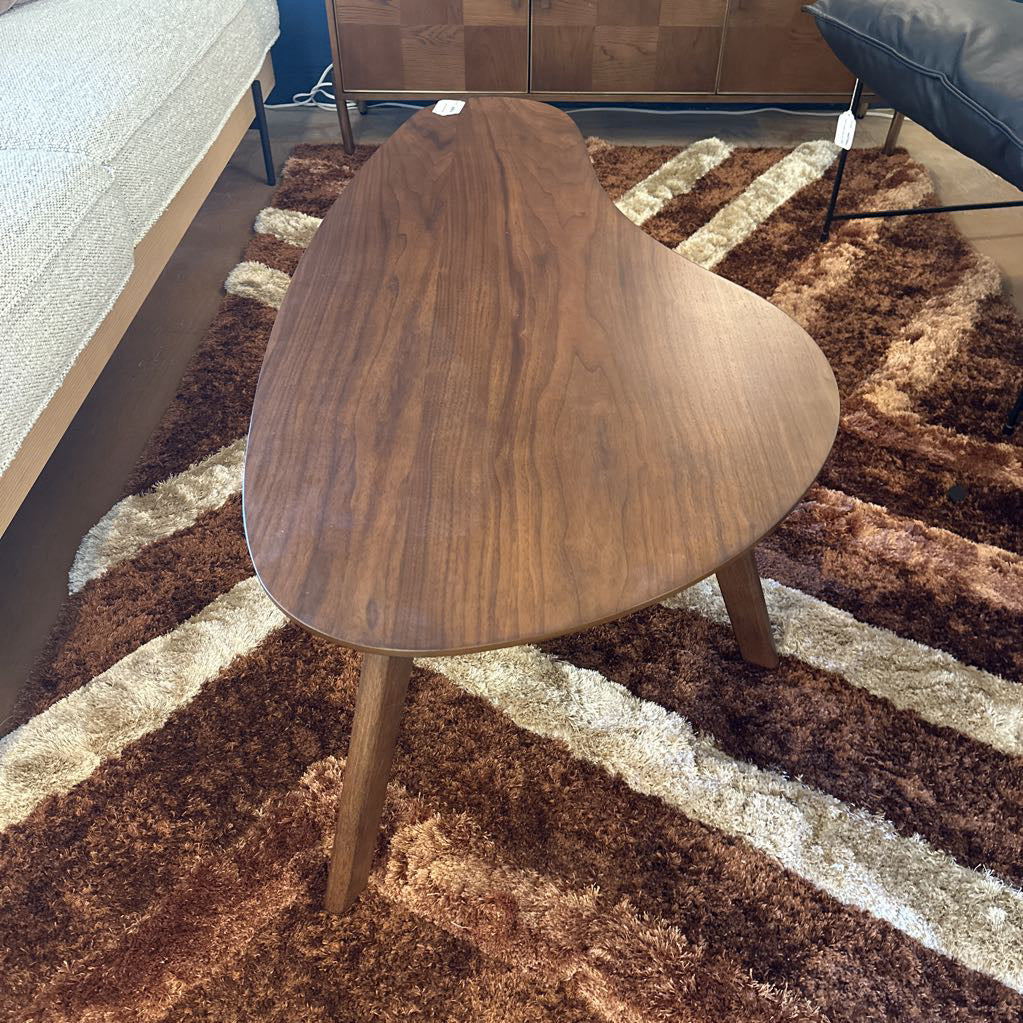 Wooden side table on a patterned rug in a room setting