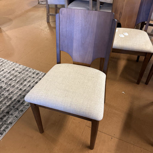 Chair with wooden backrest and fabric seat on a wooden floor