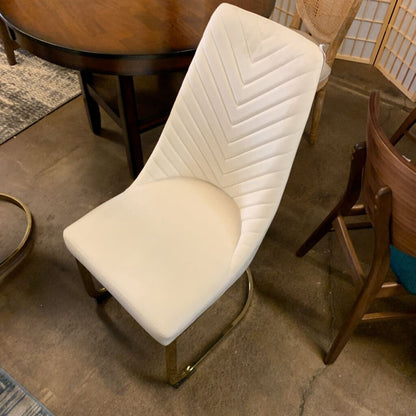 White chair with a chevron pattern on a concrete floor