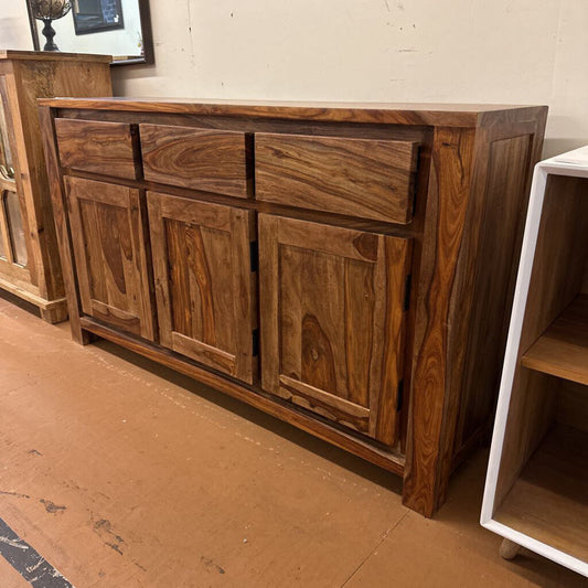 Wooden sideboard with multiple doors in a room setting