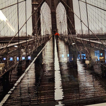 Reflections on the surface of the Brooklyn Bridge at night.