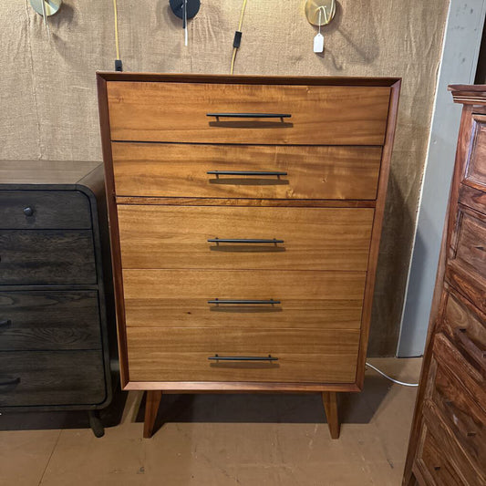 Wooden dresser with four drawers in a showroom setting