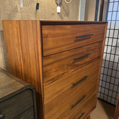 Wooden dresser with four drawers in a room setting