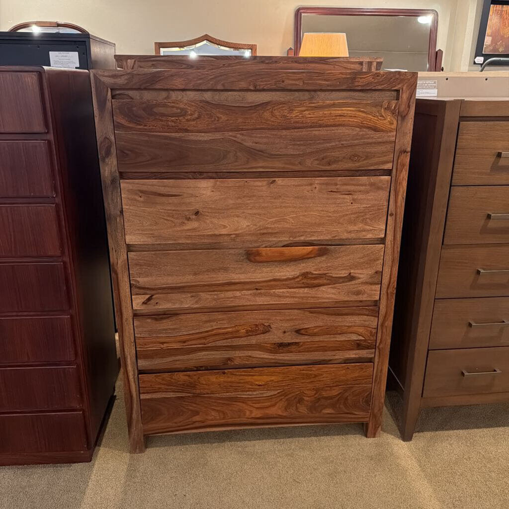 Wooden dresser with multiple drawers in a store setting