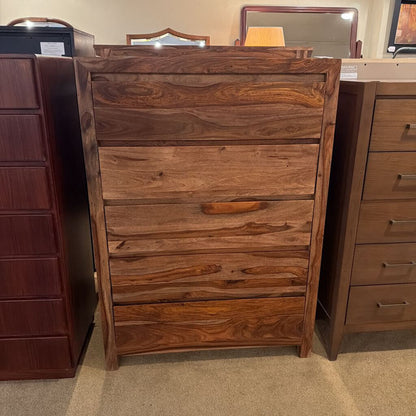 Wooden dresser with multiple drawers in a store setting