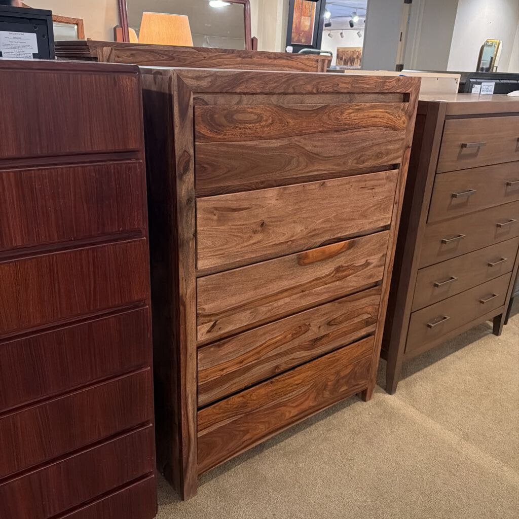 Wooden dresser with multiple drawers in a store setting