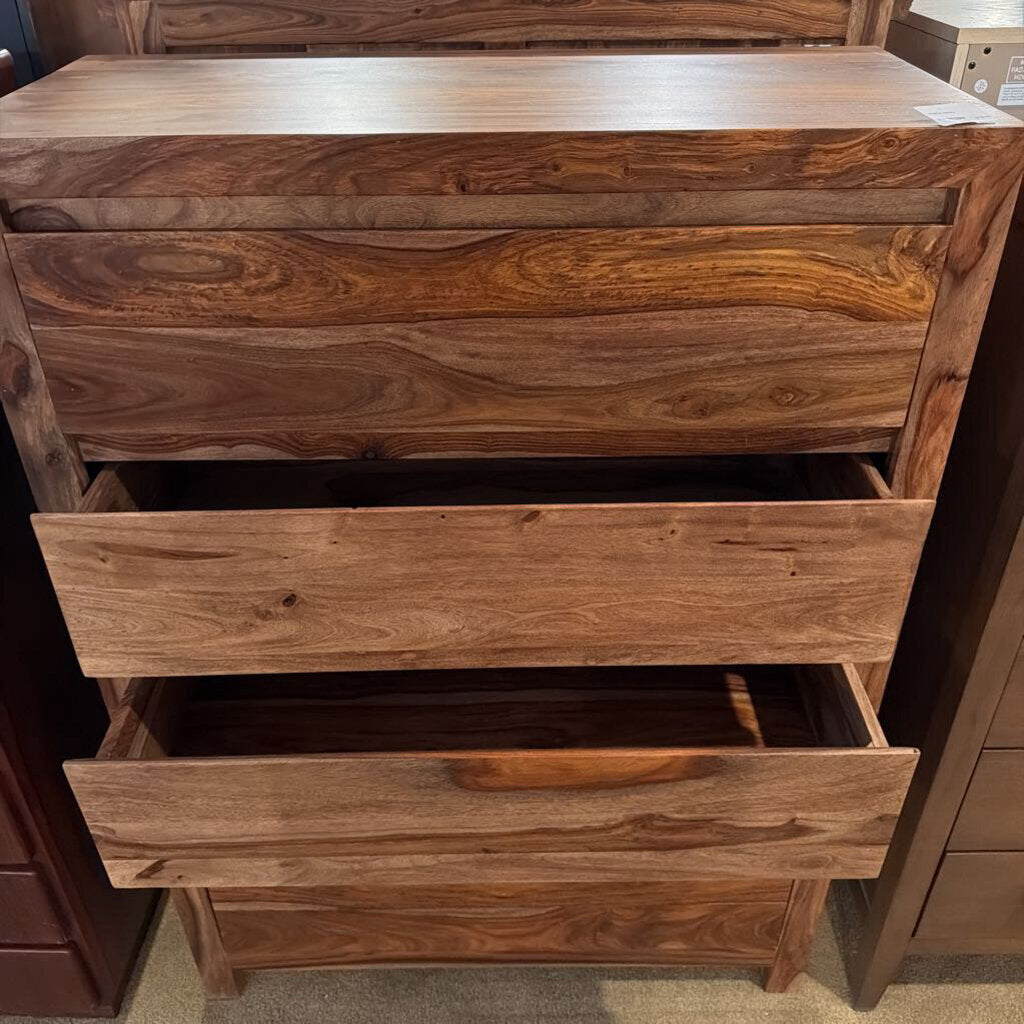 Wooden dresser with multiple drawers in a store setting