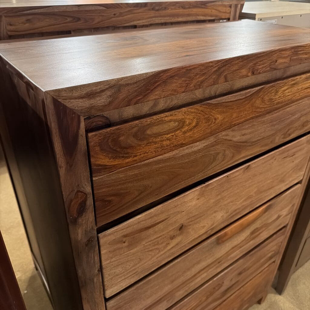 Wooden dresser with a focus on the top drawer.