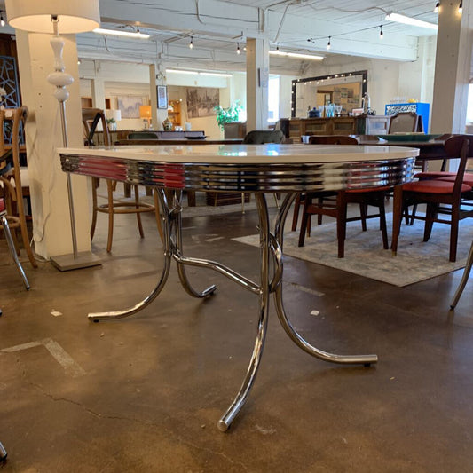 Dining table with chrome legs in a showroom setting