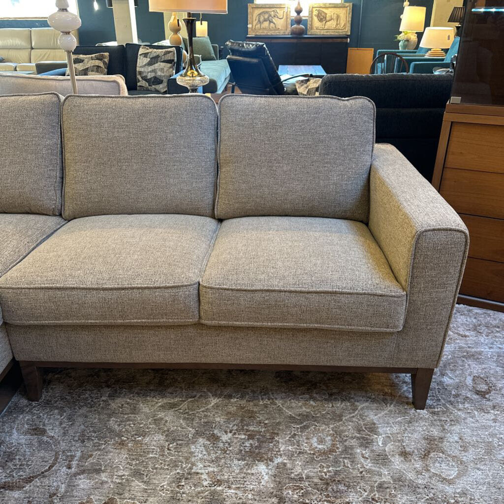 Gray sofa in a room with furniture and decor