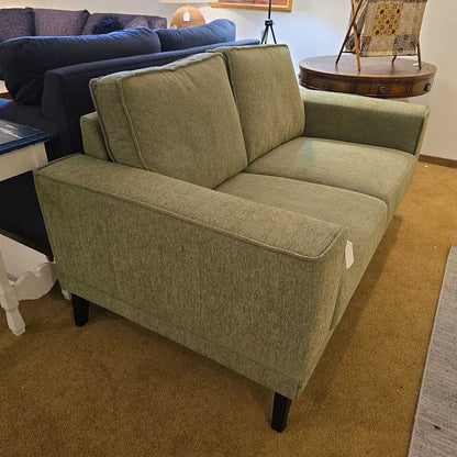 Green sofa in a room with other furniture