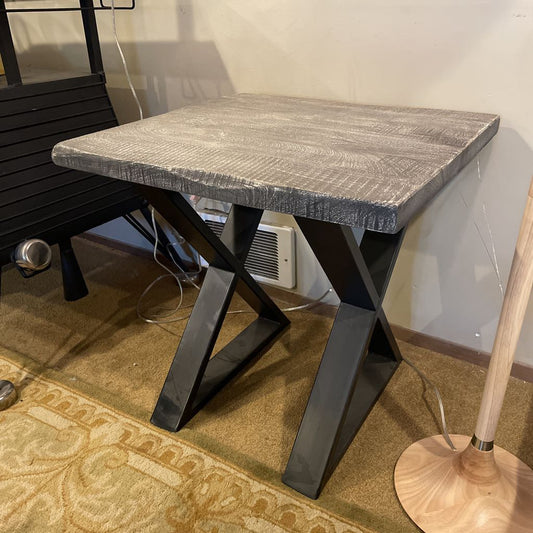 Table with a textured surface and black metal legs in an indoor setting