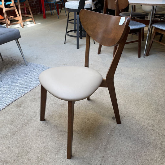 A mid-century modern dining chair with a curved wooden backrest, dark wood frame, and a rounded cream-colored upholstered seat.