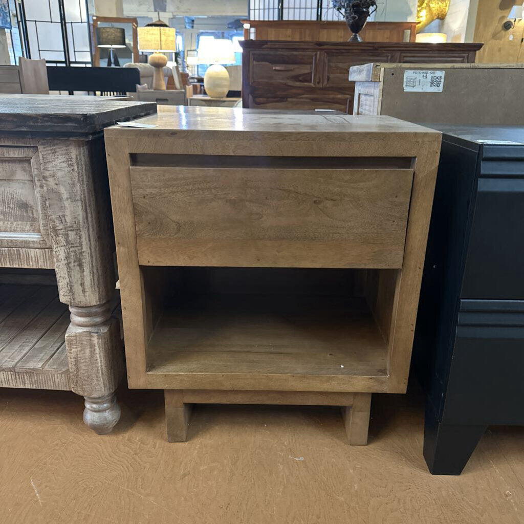 Wooden side table with a drawer in a store setting