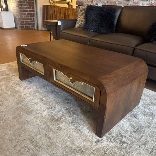 Wooden coffee table with glass panels in a living room setting