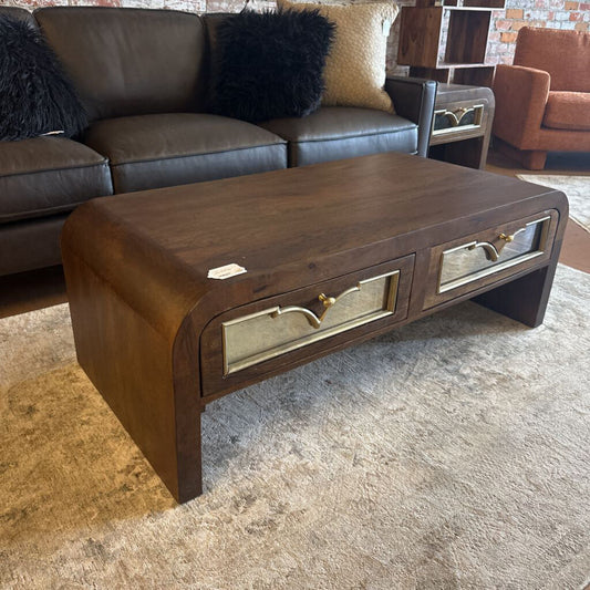 Wooden coffee table with metallic accents in a living room setting