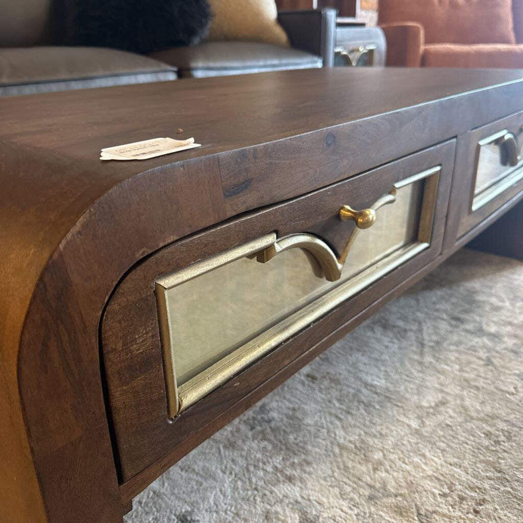 Wooden console table with brass handles in a room setting