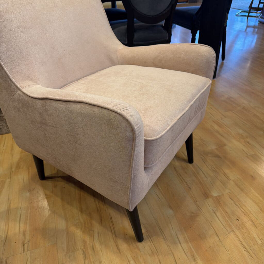 Beige armchair on a wooden floor