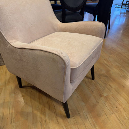 Beige armchair on a wooden floor