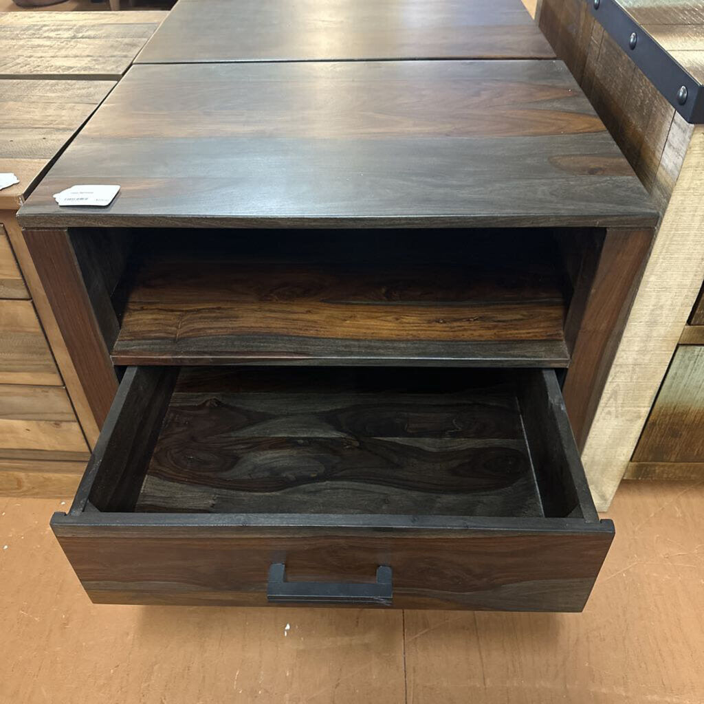 Wooden side table with an open drawer on a wooden floor