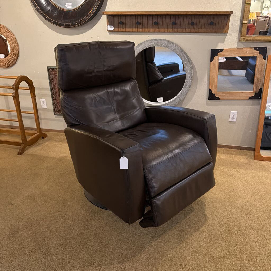 Brown leather recliner chair in a showroom setting with mirrors and shelves.