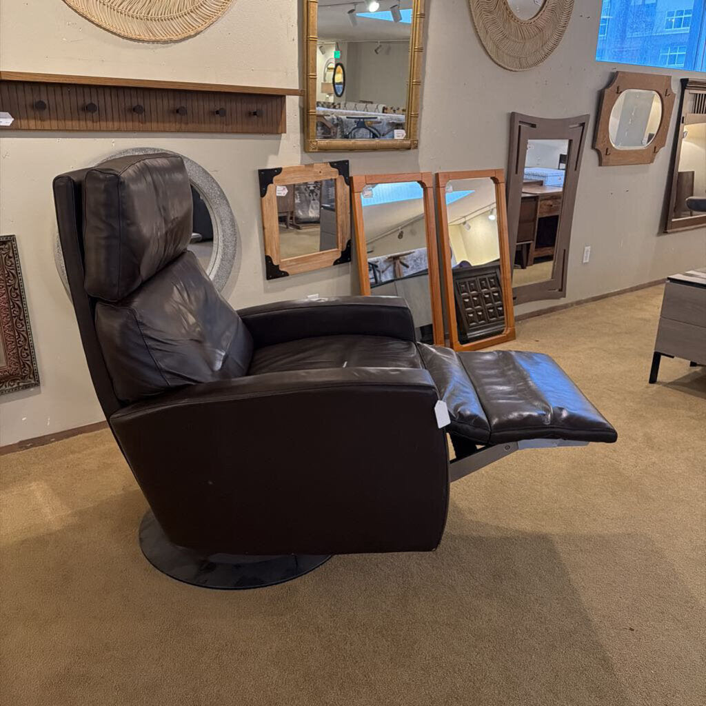 Brown recliner chair in a room with mirrors on the wall