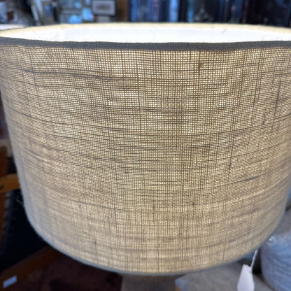 Textured beige lampshade with a blurred background