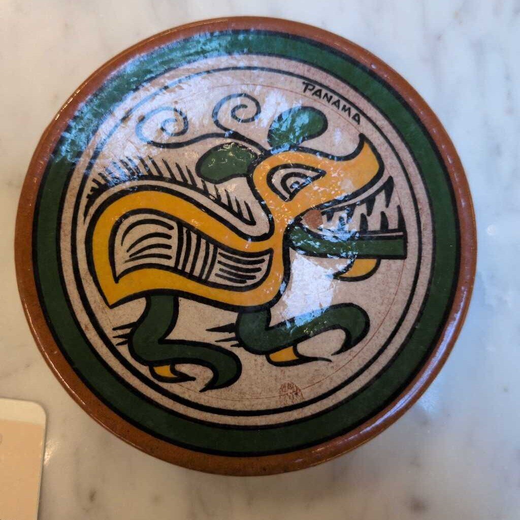 Ceramic dish with a colorful design of a panther, labeled 'Panama', on a marble surface.