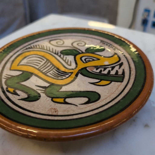 Decorative plate with a dragon design on a marble surface