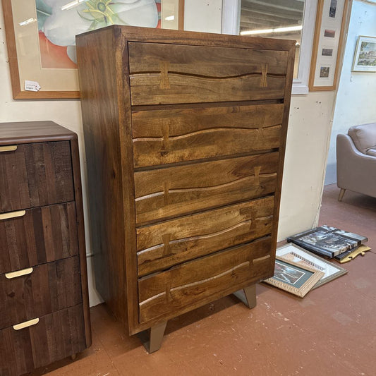 Wooden dresser with wavy grain pattern in a room setting