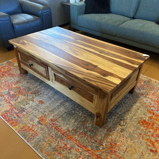 Wooden coffee table with drawers in a living room setting