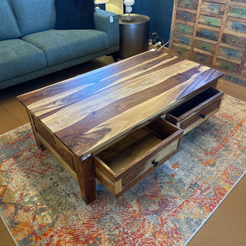 Wooden coffee table with drawers in a living room setting