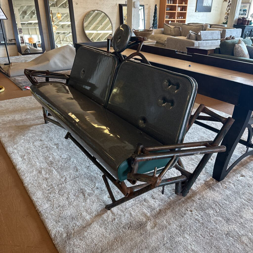 Black leather sofa with wooden frame in a showroom setting