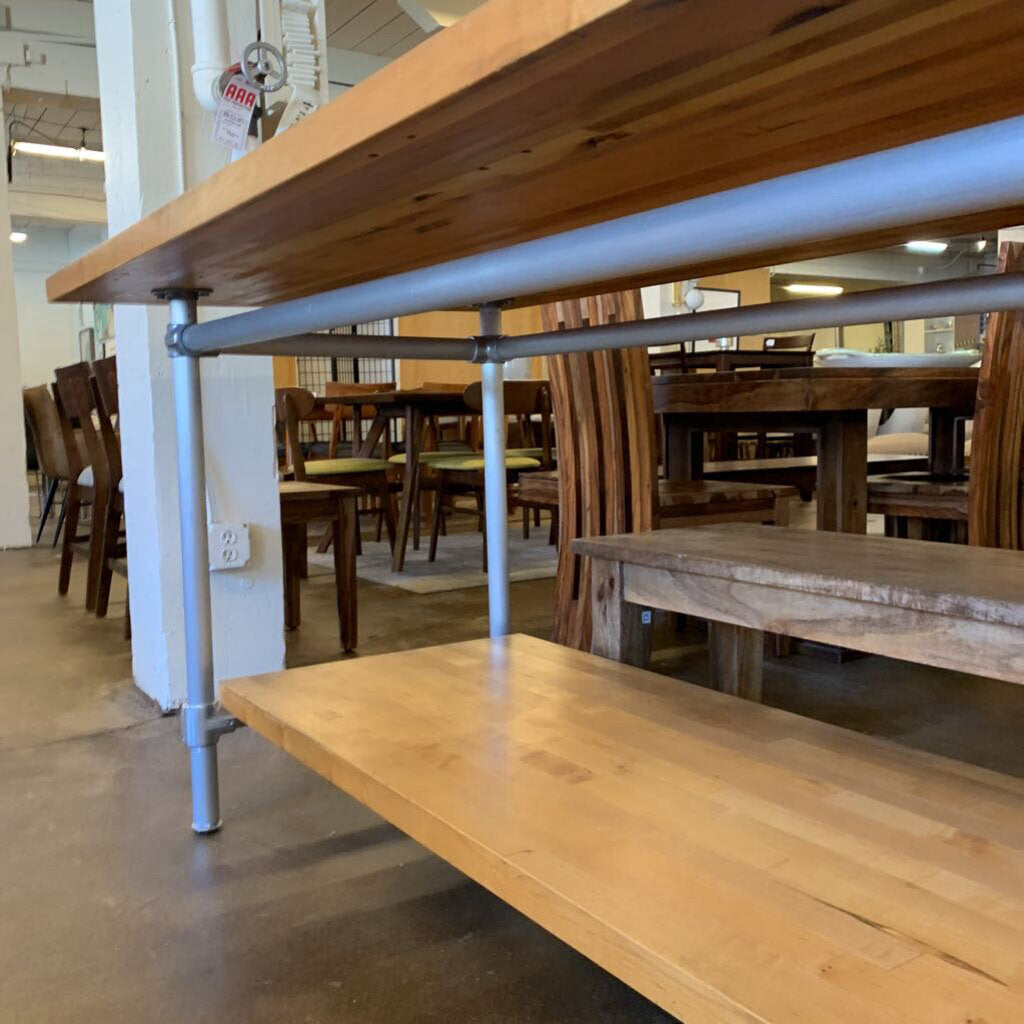 Wooden dining tables and benches in a store setting