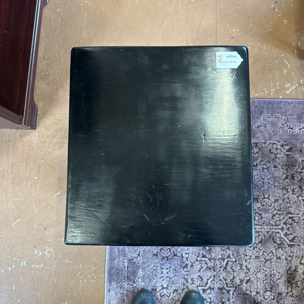 Black rectangular object on a textured surface