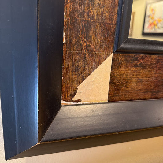 Close-up of a book corner with a dark blue spine and wooden cover.